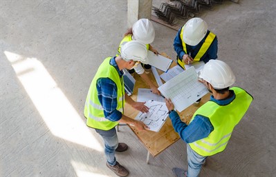 Construction workers looking at site plans